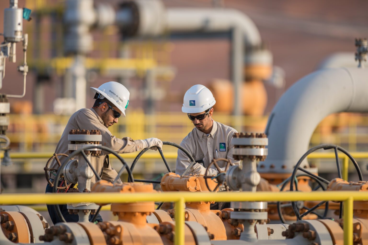 Two engineers working at a Saudi Aramco Facility.